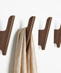 Rock-Solid Natural Walnut Wood 4 Pack Wall-Mounted Coat Hooks for a Super Entryway Glow Up, displaying smooth hooks holding a scarf.