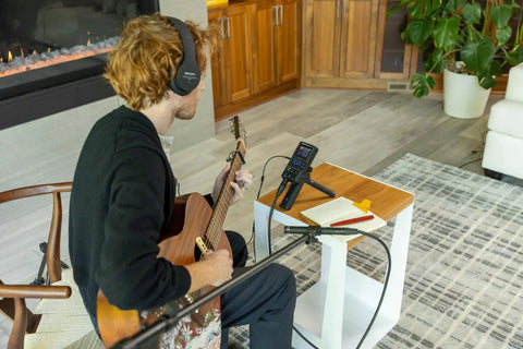 Ready To Roll 32 Bit Float MultiTrak Recorder And Stereo Bouncing Bundle Featuring Podcast Dynamic Microphone and headphones in use.