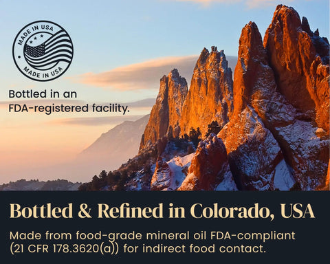 Food Grade Mineral Oil For Wood Cutting Boards And Butcher Blocks 16oz Safe For Bamboo Marble Soapstone And Stainless Steel Counters Made In USA Top Notch Kitchen Care And Conditioning For Long Lasting Finish, bottled in Colorado, USA with mountains in background.