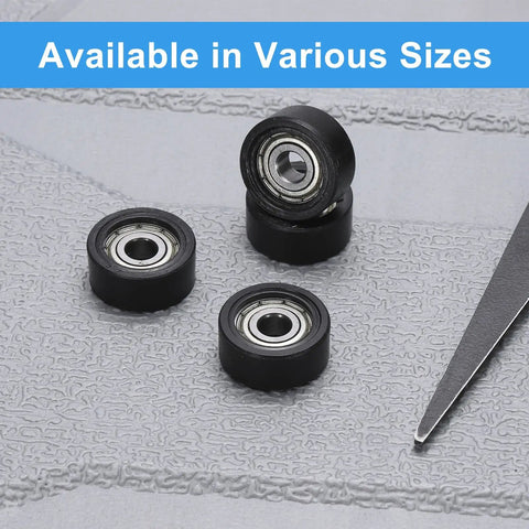 2pcs Double Shielded Ball Bearing Guide 4x14x6mm Precision Roller Idler Pulleys on gray surface for smooth operation.
