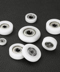 4 Pack 10X40X10mm Nylon Idler Bearings Double Shielded Chrome Steel Dead Silent Spin Pulley Wheels on black surface
