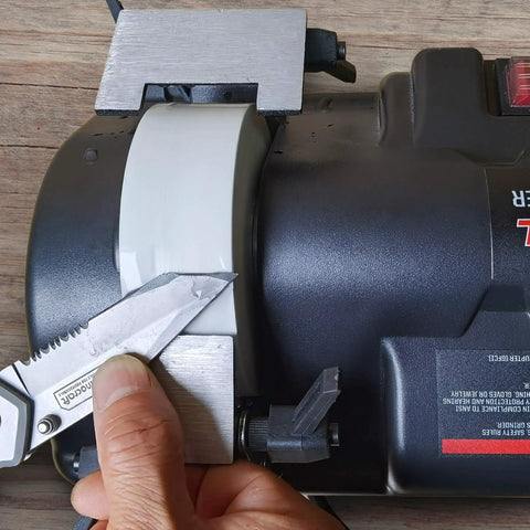 Low Speed Knife Sharpener With Wet And Dry Grinding Wheel 0.7 Amp in use with knife blade, multi angle sharpening