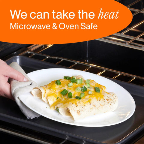 Person removing a plate with cheesy enchiladas from the oven, demonstrating microwave and oven safe dinnerware.