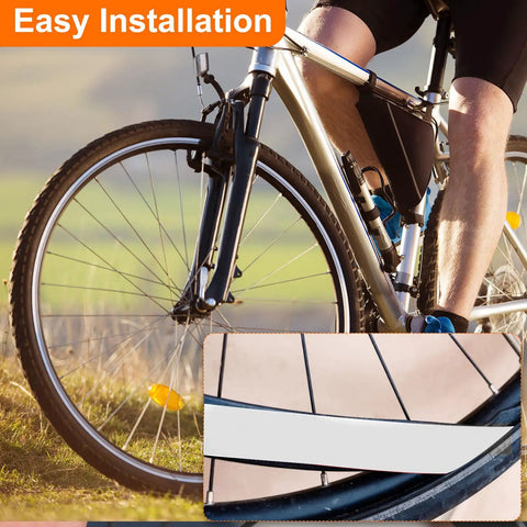 Cyclist with 26 inch bike showing Four Pack 26 Inch Bike Tire Liners For Puncture Proof PU Inner Tube Flat Protection For Mountain And Road Bikes No Fuss Install And Stay In Place Transparent installed