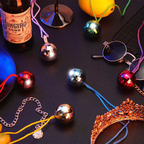 Disco Ball Necklaces 42 Pcs Multicolor Party Chain Set with reflective balls on a table with party accessories.