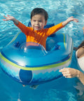 Child in Remote Control Baby Pool Float With Enclosed Propeller Guard, Motorized Toddler Boat For Ages 1 To 4, in pool