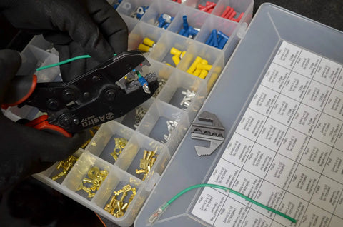 Using 7-Piece Quick Interchangeable Ratchet Crimping Tool Set for Wire Terminals with assorted connectors in a box