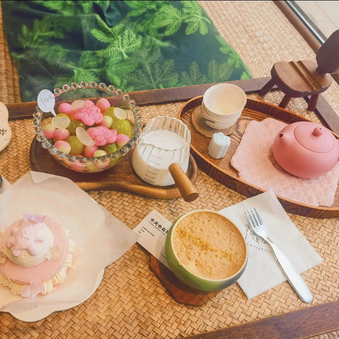 Coffee table setup with Double Scale Glass Measuring Cup With Wooden Handle For Coffee And Espresso, and assorted desserts.