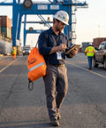 Three Pack Safety Glasses Featuring Zero Sweat Anti Fog Vision And Secure Grip Fit Designed For Construction Sites Shooting Ranges And Diy Workshops Tough As Nails Crew Essential Gear worn by a worker using a tablet on site.