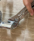10 Inch Locking Adjustable Wrench With Quick Release And Inch Metric Scale Rust Resistant Precision Machined Jaw And Worm Gear Drop Forged Carbon Steel For Auto Repair Plumbing And DIY Maintenance 2.7 X 0.75 Inch being used to grip a plumbing fixture.