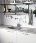 Modern kitchen sink area with brushed nickel cabinet pull handles, dishes, and cooking accessories for effortless style. Upgrade Your Kitchen Game With These Smooth Brushed Nickel Cabinet Pull Handles Featuring A Tight Fit Modern Vibe And Heavy Duty Construction Ideal For Cabinets And Drawers Grab This Four Pack Deal For Instant Home Refresh.