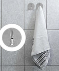 6 Pcs Stainless Steel Wall Hooks Zero Damage Install No Sweat Mount heavy duty hooks holding a towel on a tiled wall.