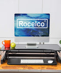 32 Inch Height Adjustable Standing Desk Converter With Slide Out Keyboard Tray and Dual Monitor Riser on a wooden table with decor.