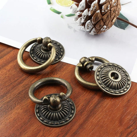 Legit Vintage Bronze Drop Ring Cabinet Knobs With Mounting Screws Solid Zinc Alloy Furniture Drawer Pulls For Dresser And Cupboards Smooth Glide No Fuss Heavy Duty Hardware Six Piece Set close-up view of three antique knobs on wooden background