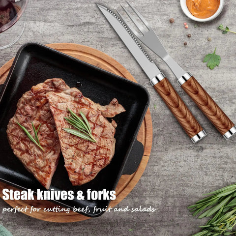 Grilled steak in a cast iron pan with wooden-handled steak knife and fork on a stone surface.