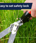 Hand using Rotating Handle Grass Shears For Precision Edging And Hedge Trimming with easy-to-set safety lock in garden use.