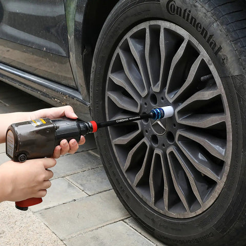 Half-Inch Drive 8 Inch Color-Coded Torque Extension Bar Set, 10-Piece in use with impact wrench on car wheel lug nut