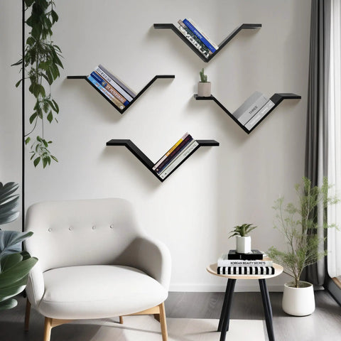 Super Sleek Black Wall Mount Bookshelf Set Of Two With Sweet Wing Shaped Design That Offers Hella Spacious Storage While Giving Your Space Total Modern Vibes, featuring books and plants.