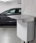 Premium Stainless Steel Outdoor Charger Rain Cover Weatherproof Charging Station Protector mounted beside grey electric vehicle