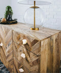 Four Crisp White Geode Cabinet Knobs With Burnished Gold Plating Designed To Level Up Your Kitchen Drawers Bedroom Dressers And Closet Doors While Adding A Clean Modern Vibe To Any House on a wooden dresser.