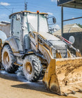 Construction backhoe loader being cleaned with Touchless Heavy Equipment Cleaner One Step Detergent Soap Concentrate Foam