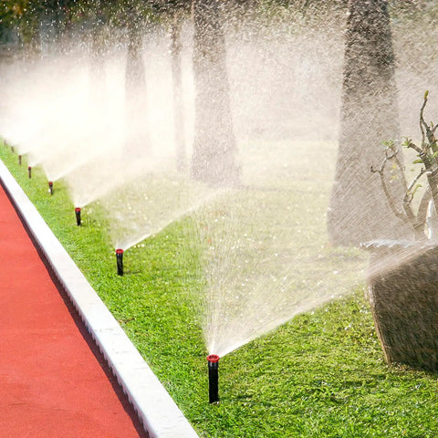 24 Piece Variable Arc Nozzles Replacement Pop Up Sprinker Heads Compatible With Standard Lawn Irrigation Systems spraying water on grass.