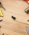 50 Pack Server Rack Cage Nuts And Mounting Screws Kit With Ultra Heavy Duty Metal Washers on a wooden surface with tools.
