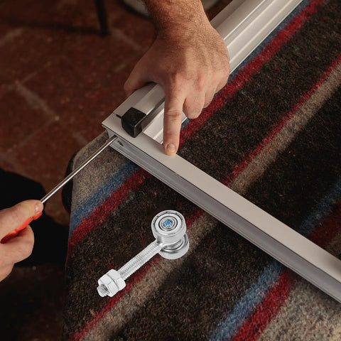 Installation of Straight Up Heavy Duty Steel Sliding Door Rollers With Double Bearing Construction on metal track.