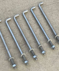 Half Inch By Ten Inch Threaded Concrete Anchor L Bolts With Nuts And Washers Included Hot Dipped Galvanized displayed on concrete.