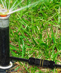 180 Pack Outdoor IP68 Waterproof Junction Box With 3 Pin Wire Connectors near a garden sprinkler on grass.