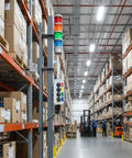 Top Notch Four Stack Led Andon Tower Light With Built In Buzzer For Industrial Workstations signaling in a warehouse aisle.