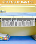 Compact Mesh Shoe Storage Hangs Beside Bed With 4 Hooks For RV Camper And Home To Stash Sneakers And Boots While Keeping Floors Tidy. Gray fabric hanging shoe organizer with mesh pockets.