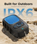 Wearable Bluetooth Speaker With All Day Battery Life And Clip On Convenience For Job Sites Water Resistant Pro Portable Speaker With Built In Mic For Hands Free Music And Calls Blue Non Magnet placed on wet sand showcasing water resistance