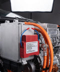 Close-up of a Hot Aerosol Fire Extinguishing Device mounted on an engine, showcasing safety gear for fire prevention in vehicles.