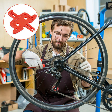 Mechanic using Eight-Piece Orange Bicycle Brake Pad Spacer Set For Hydraulic Disc Brakes Durable Plastic Pad Spreader Insert Tool
