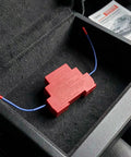 Auto Aerosol Fire Extinguishers With Dual Nozzles For Slick Hands Off Flame Control sitting in a storage compartment.
