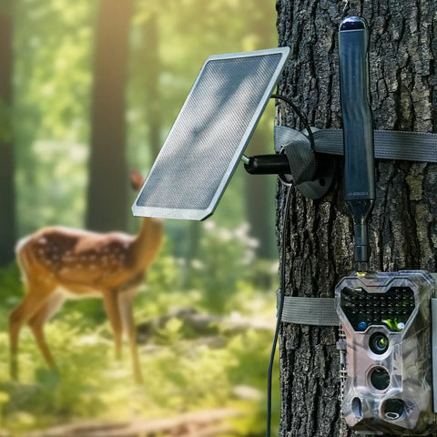 Keep Your Trail Cams Humming And Fully Loaded Year Round With This Versatile Multi Voltage Solar Charger Offering 12V 9V And 6V Output Modes Paired With A Beefy Thirteen Foot Cable For Always Ready Outdoor Tracking Expeditions, mounted on a tree with a blurred deer in the background.