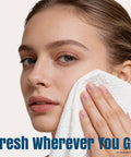 Woman using On The Go Mini Water Activated Towel Tablets, Disposable Washcloths That Expand With Water on face, soft and lint-free
