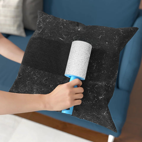 Using Extra Sticky Lint Roller Mega Value Set With 400 Sheets for pet hair removal on black cushion