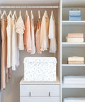 Built Tight Foldable Storage Bin With Heavy Duty Handles And Velcro Close Top For No Sweat Organization in a closet with dresses.