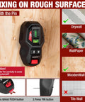 2-In-1 Laser Level With Magnetic Stud Finder on wooden surface, demonstrating use on drywall, wallpaper, and wooden walls.
