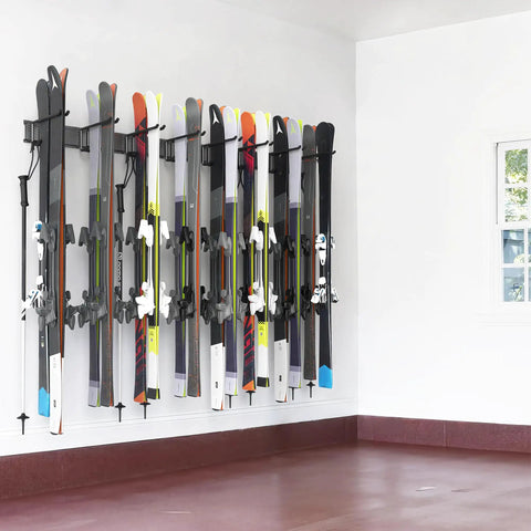 Modern Top Shelf Heavy Duty Wall Mount Ski Rack Solid Garage Game Changer To Securely Hold 16 Pairs Of Long And Short Alpine Skis Plus Snowboards With Hook Clamps mounted with skis on a white wall.
