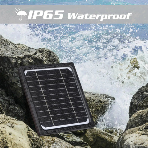 Hella Durable 5W 12V Solar Panel With 5200mAh Battery For Trail Cameras And Game Hunters IP65 Waterproof Charger Kit on rocks near water.