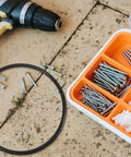 Premium Rubber Belt Replacement For Continuous Sealing Machine 2 Pack with a black rubber ring, screws, and tools on a work surface.