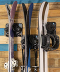 Badass Gravity Lock Ski And Snowboard Wall Storage Rack Holds 3 Pairs Damage Free Gear Saver With Anti Slip Pad Protects Tips Tails And Rockers For Safe Indoor Equipment Organization In Black with mounted skis.