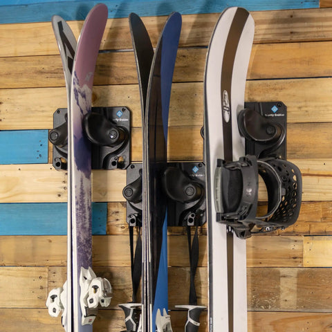 Badass Gravity Lock Ski And Snowboard Wall Storage Rack Holds 3 Pairs Damage Free Gear Saver With Anti Slip Pad Protects Tips Tails And Rockers For Safe Indoor Equipment Organization In Black with mounted skis.