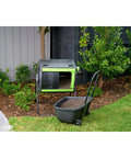 Dual Chamber 48 Gallon Compost Tumbler With Geared Rotation And Cart Access in a garden setting