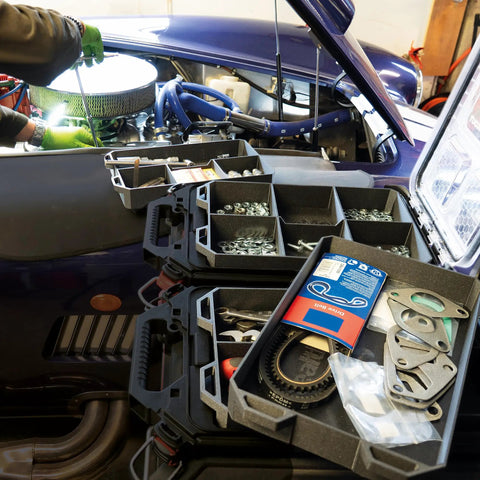 Quad FlexiTray Flexible Tool Tray System For Milwaukee PACKOUT Compatible Organizer in use on car engine, workshop setting.