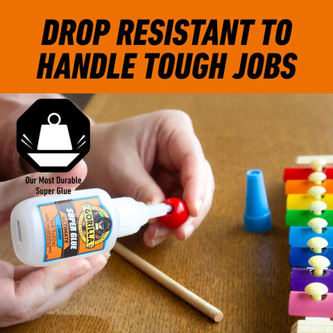 Tough As Nails Super Glue Pack Of Six 15 Grams Tubes clear bonding liquid used for fixing a red bead on a wooden stick.