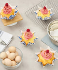 Decorated cupcakes in Bulk 4000 Pack Greaseproof Cupcake Liners 10.2 Ounce Disposable Oven and Freezer Safe Paper Muffin Cups.